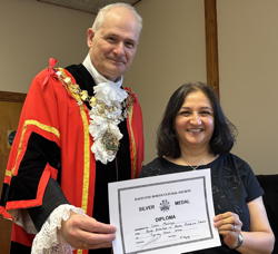 Lata Malviya receives award for best exhibit in home produce.